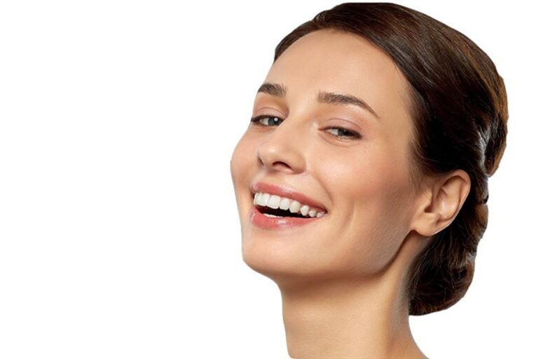 Smiling woman turning her head to show her cheek and jawline