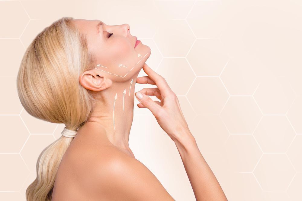 Woman touching her neck and jawline