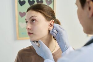 Clinician examining a patient's earlobe